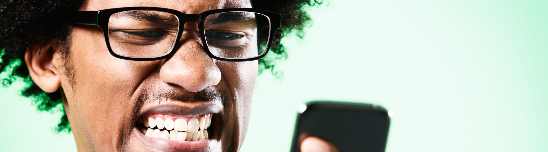 Man wincing at phone