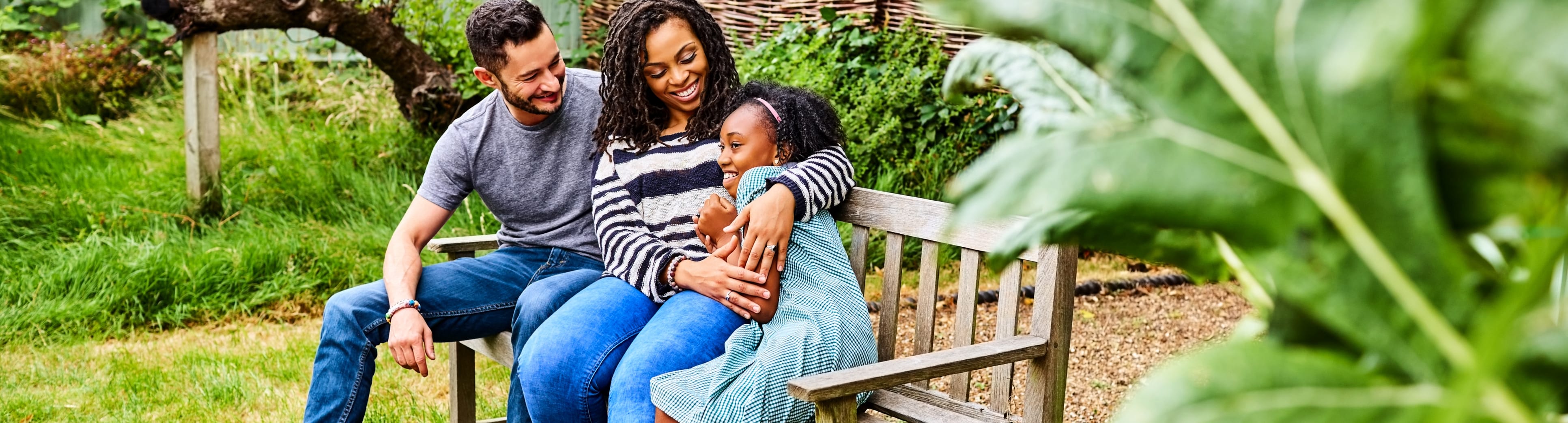 happy family sitting on bench