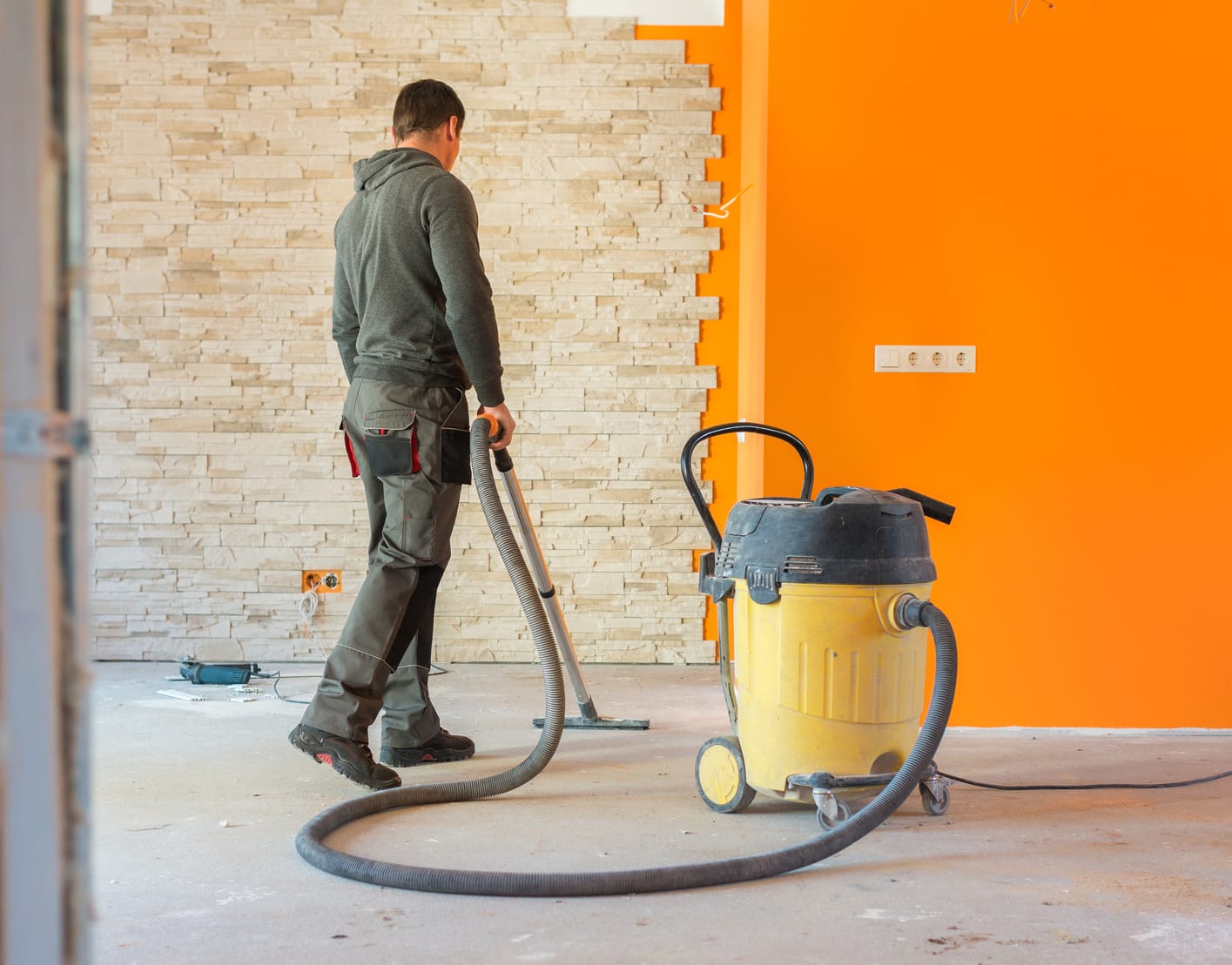 person using wet/dry vacuum