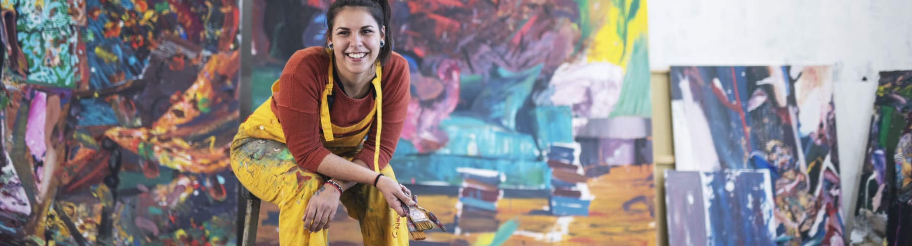 Hispanic artist with paintings