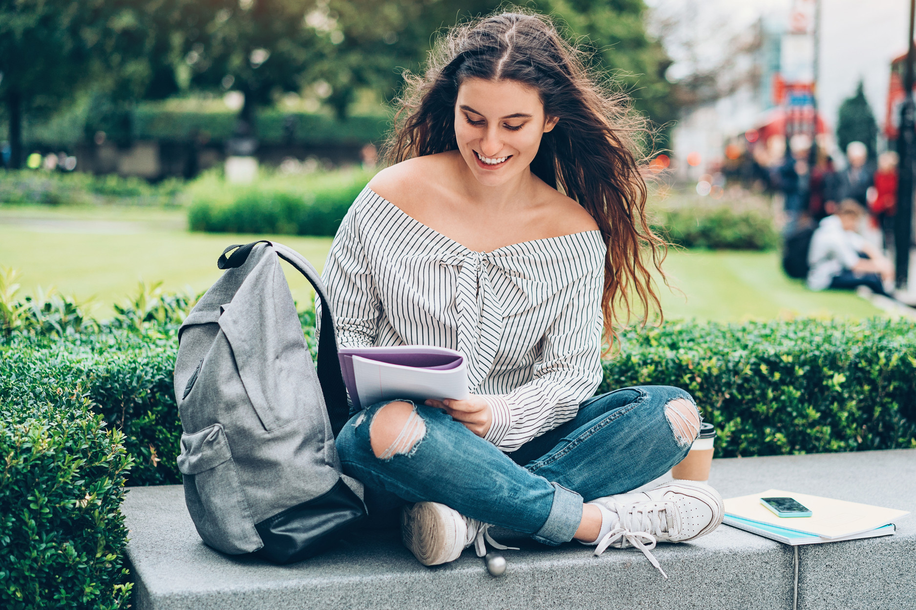 Teen_Doing_Homework_on_a_Bench.jpg