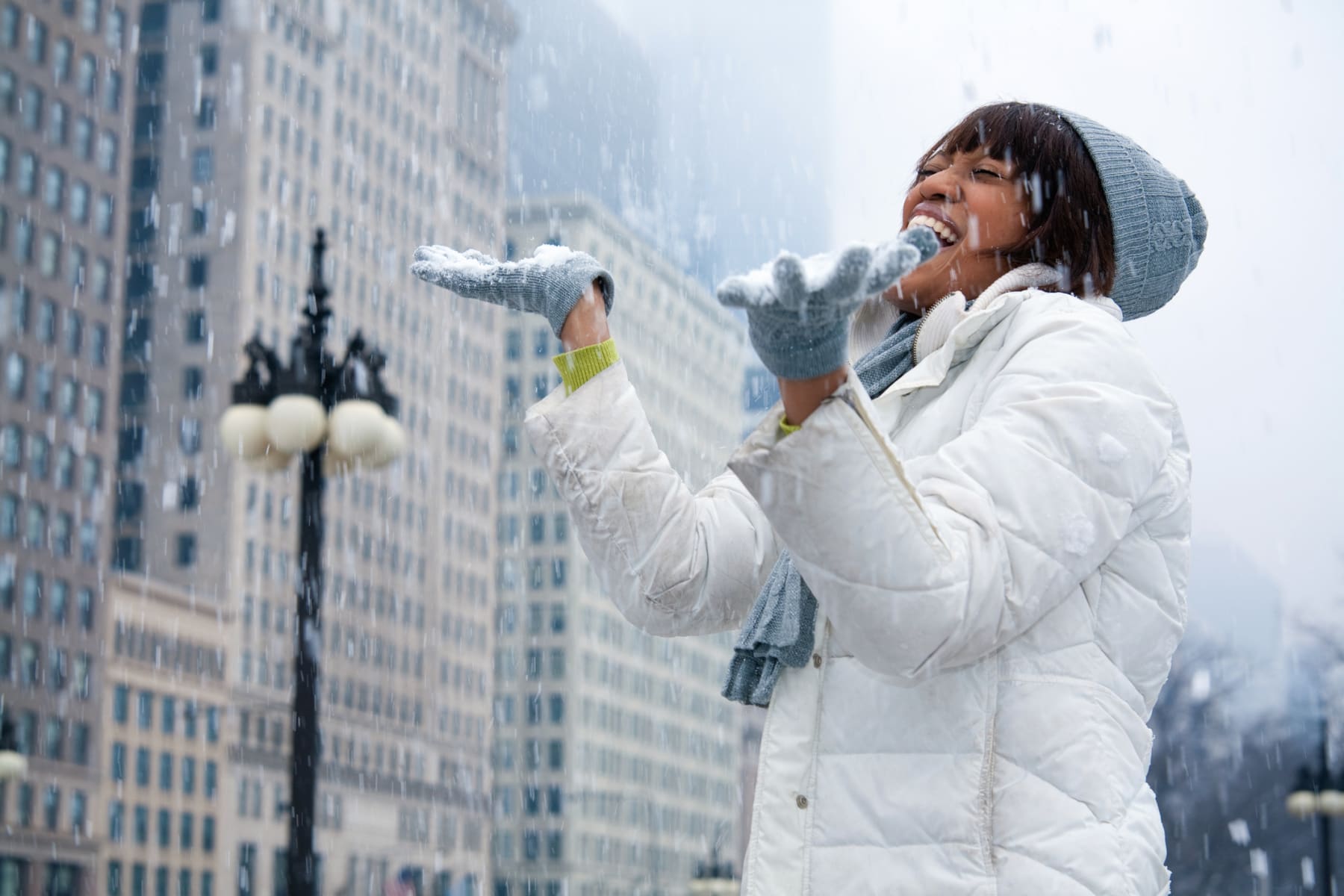 Woman in the City Enjoying Snow