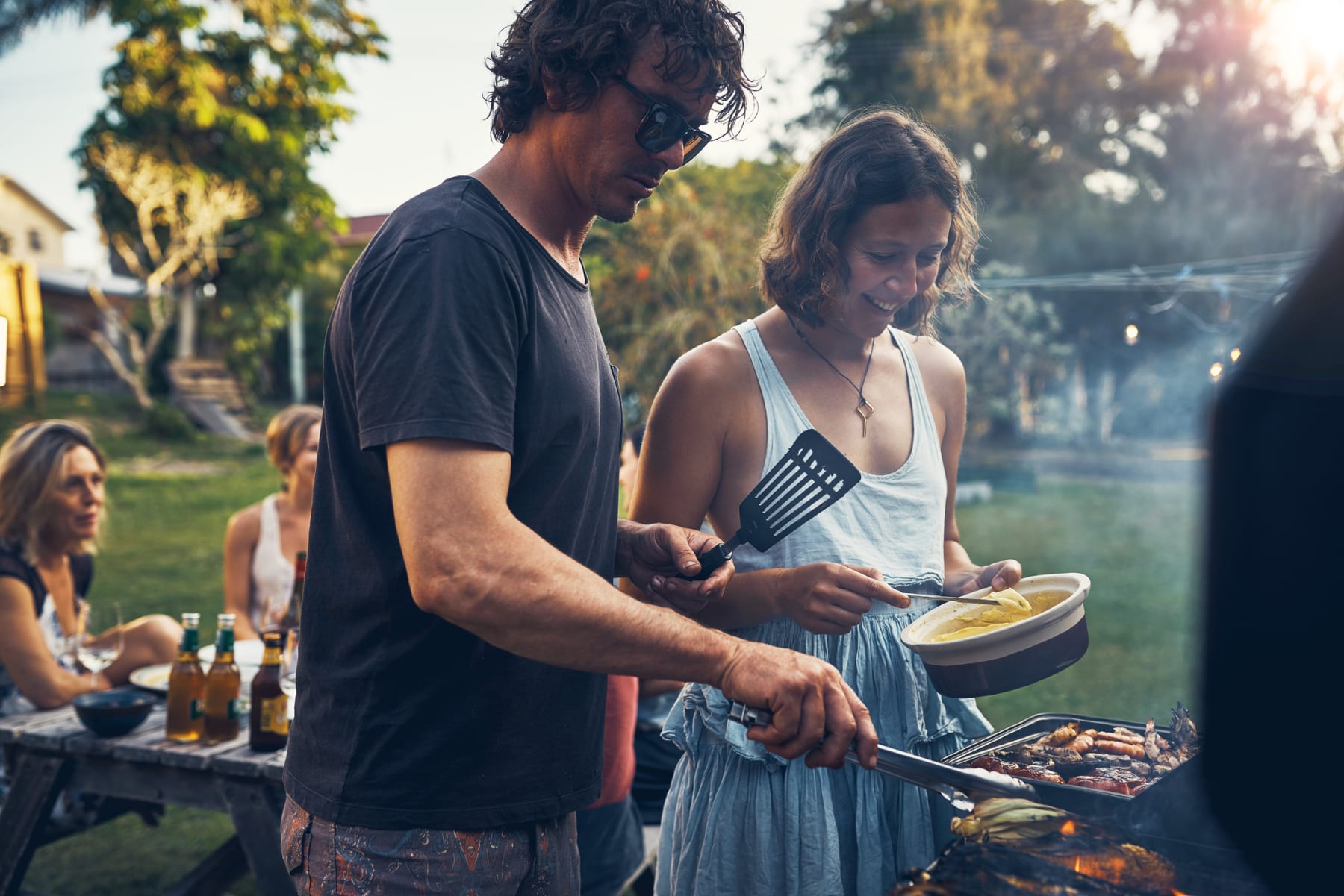 man and woman grilling food