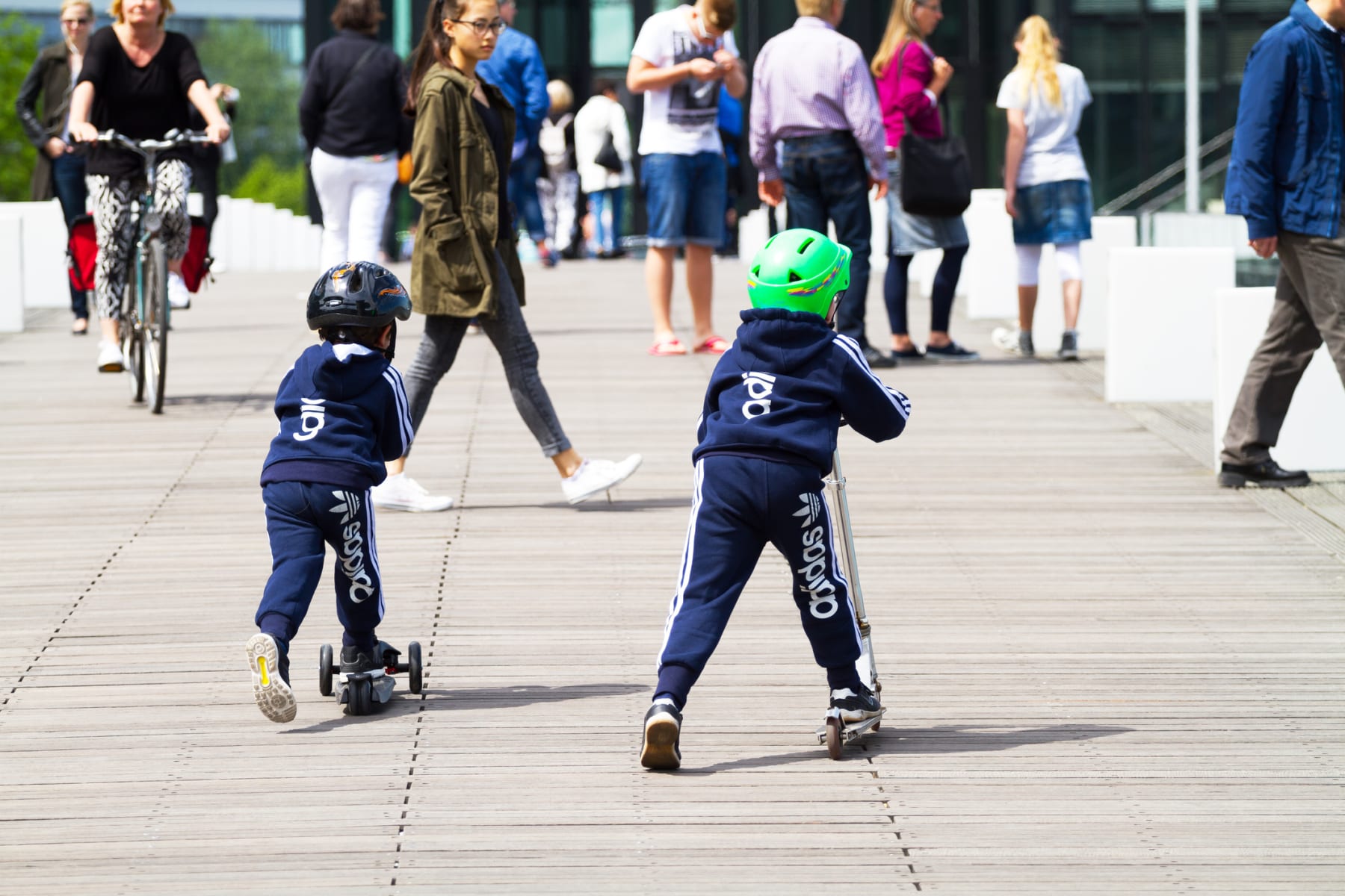 kids in adidas clothing riding scooters