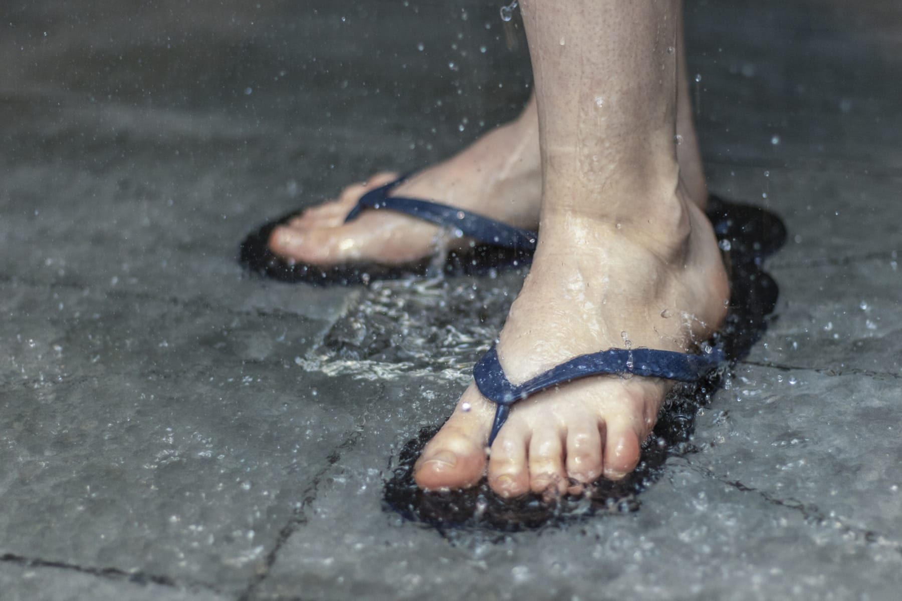 person wears flip-flops in shower