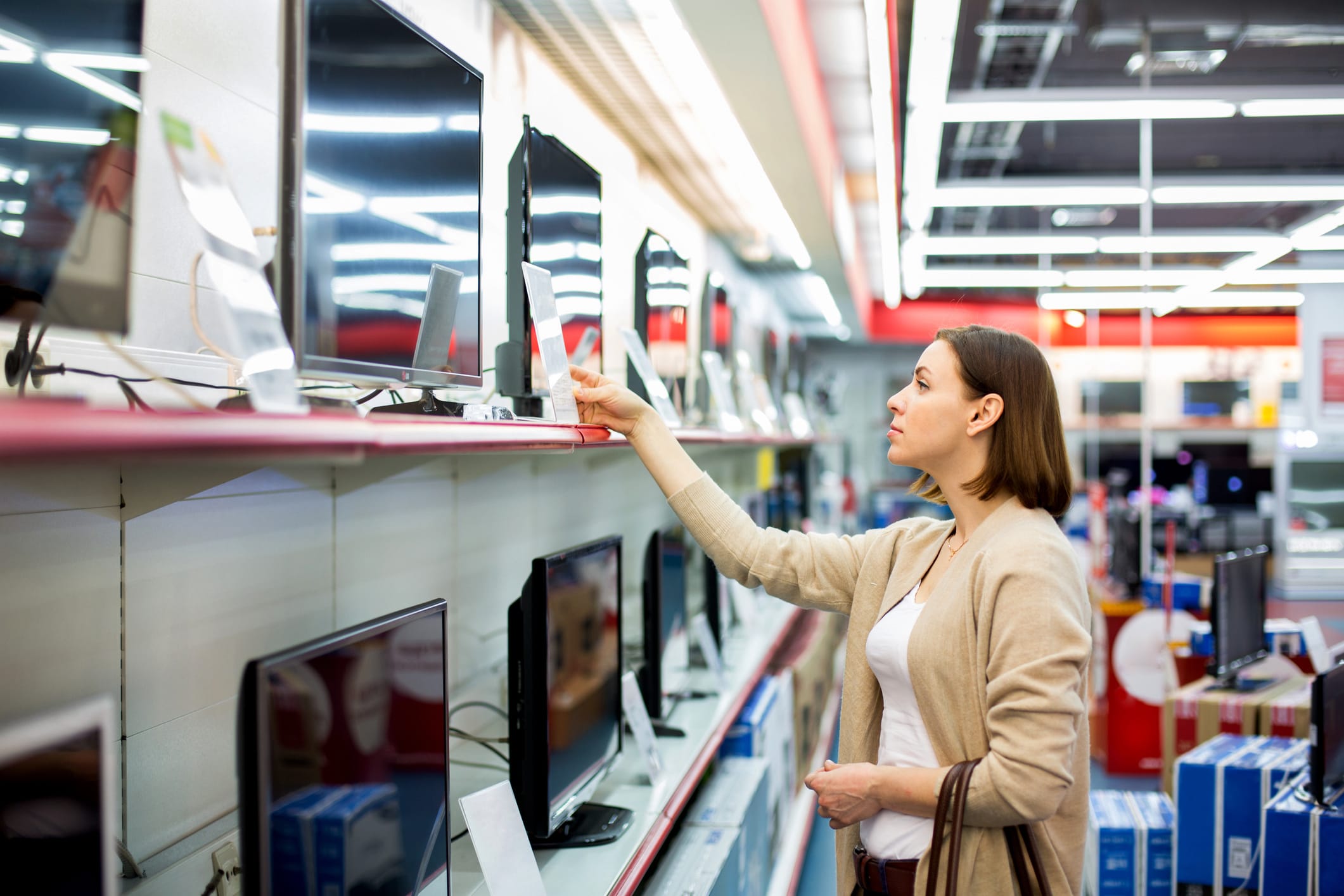 woman looking at TVs