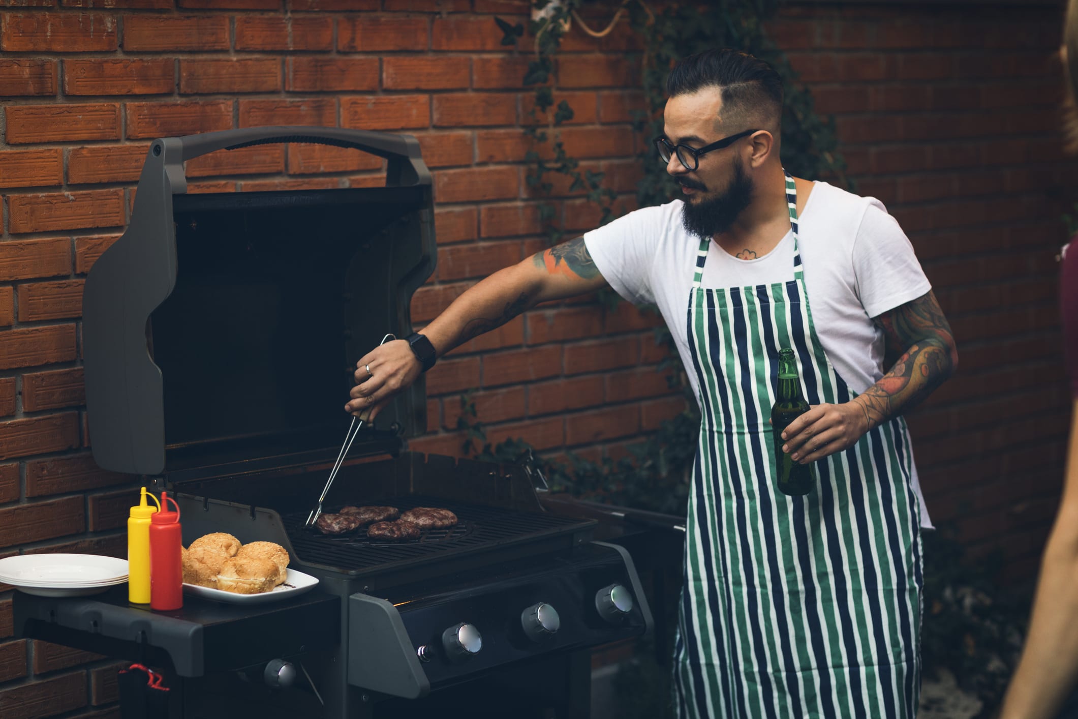 person grilling burgers