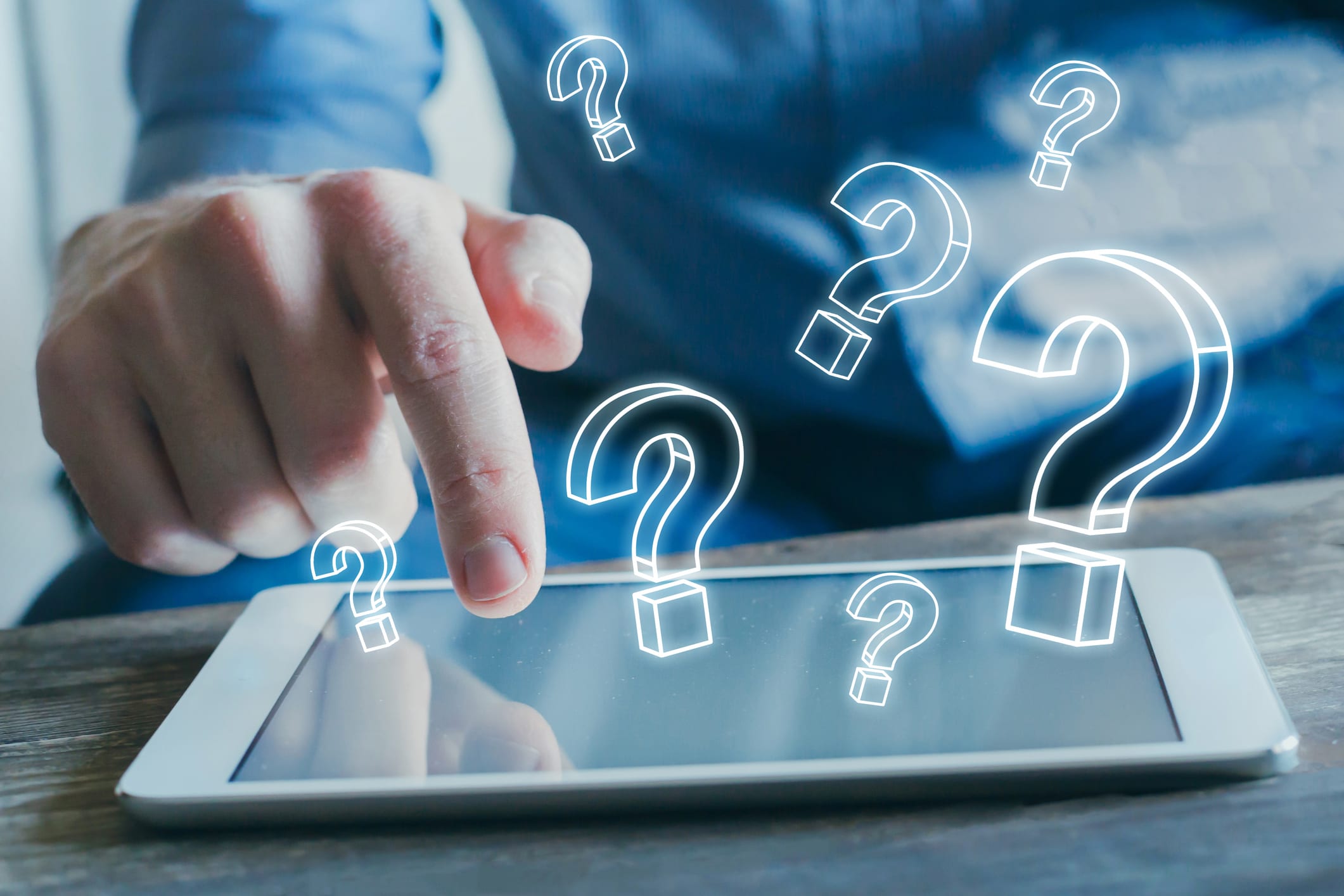 tablet and question marks