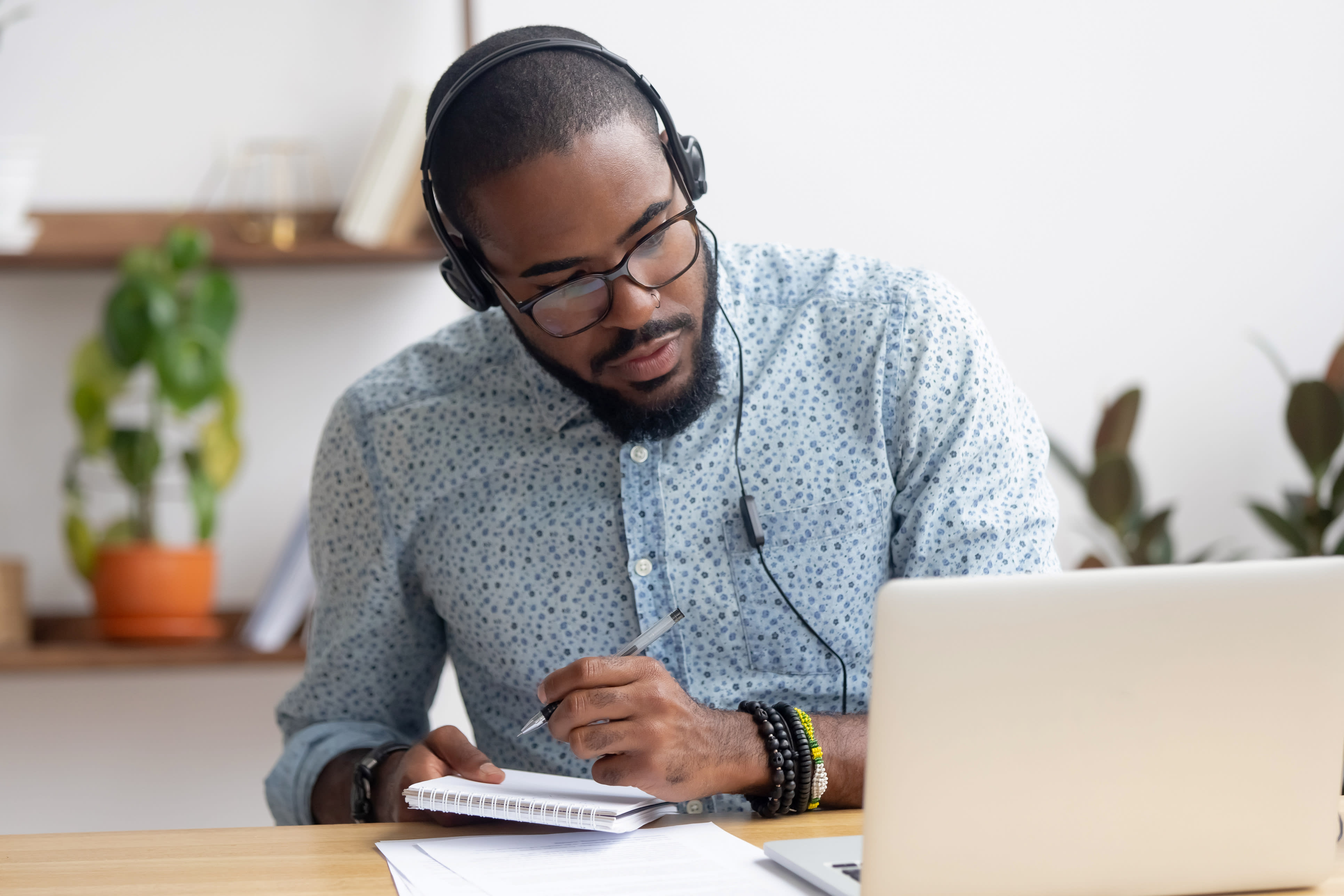 man listening and taking notes