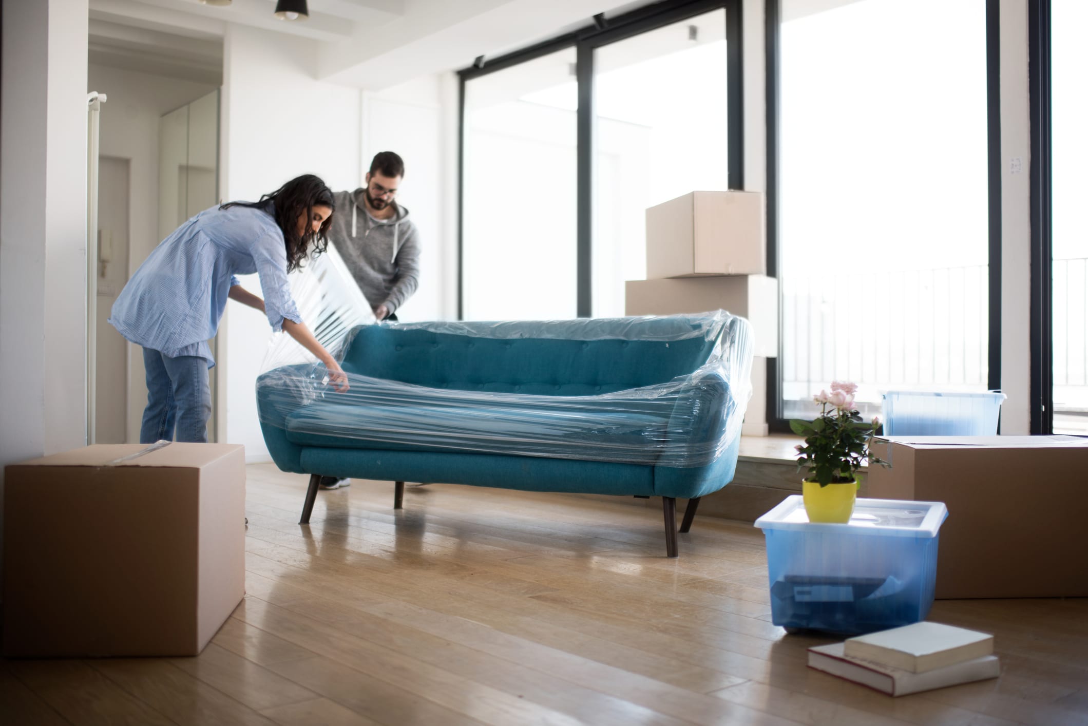 Young Couple Unwraps a Sofa in Their Apartment