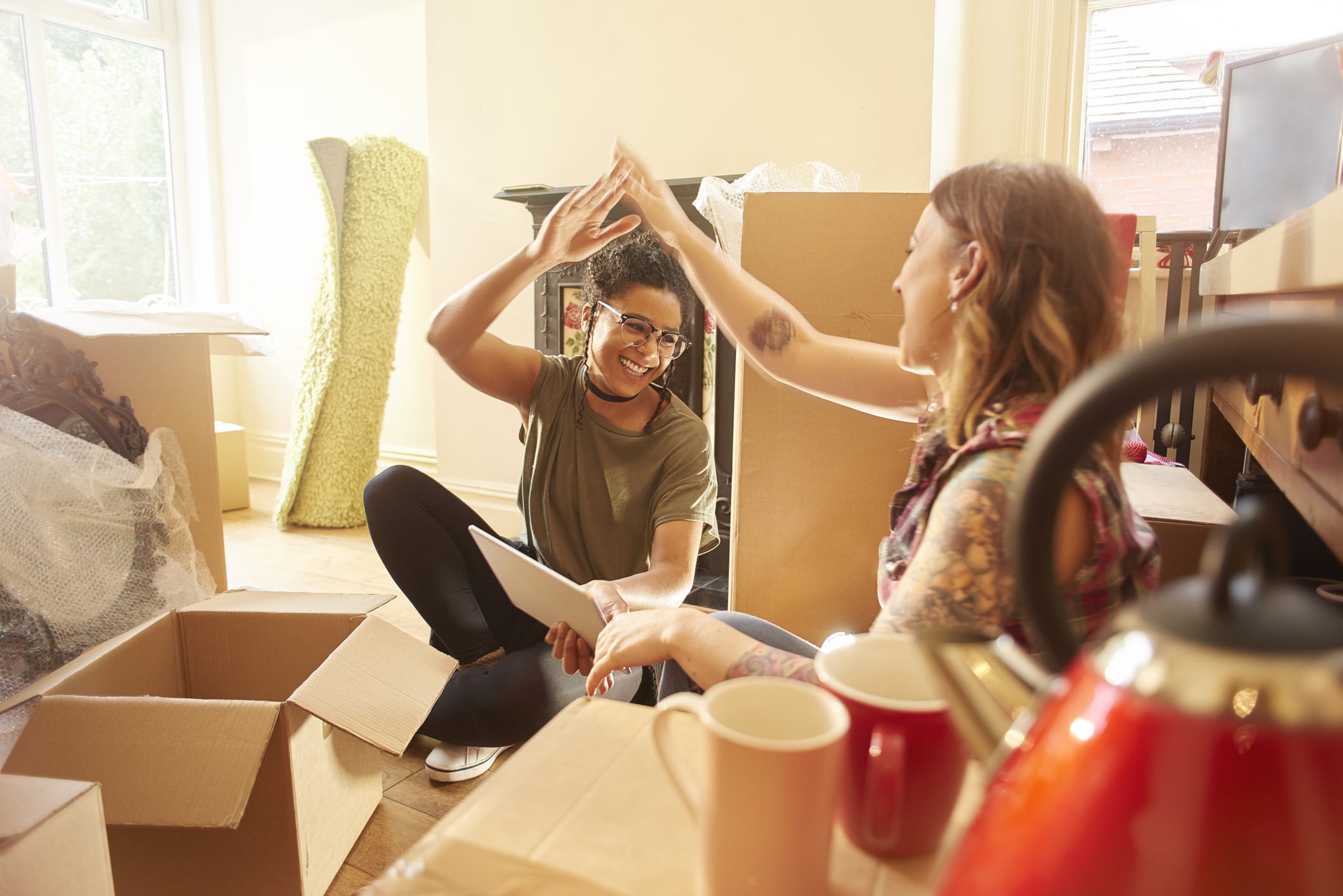 Happy Female Couple Celebrates in New Home
