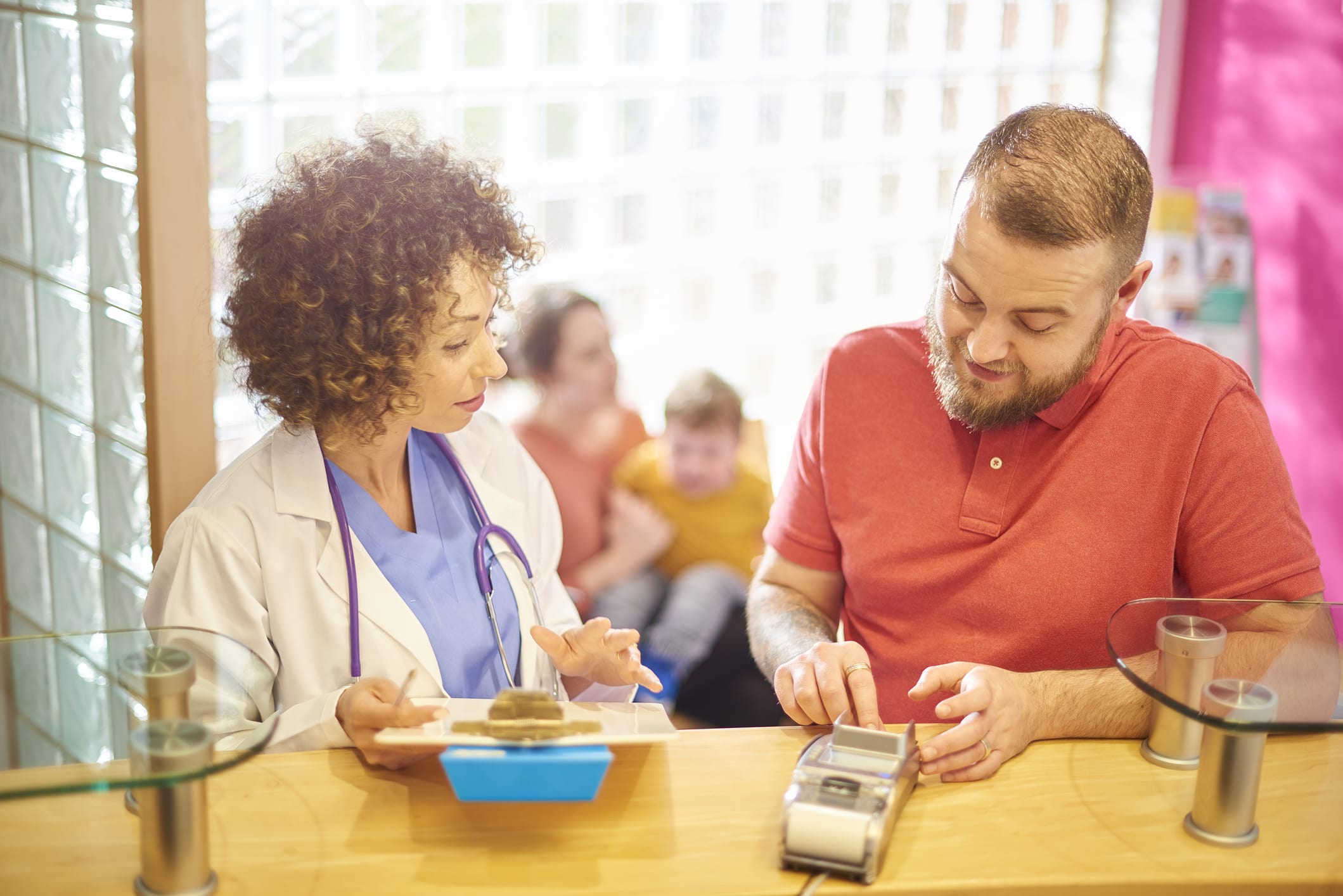 Patient Pays Medical Bill at the Reception Desk