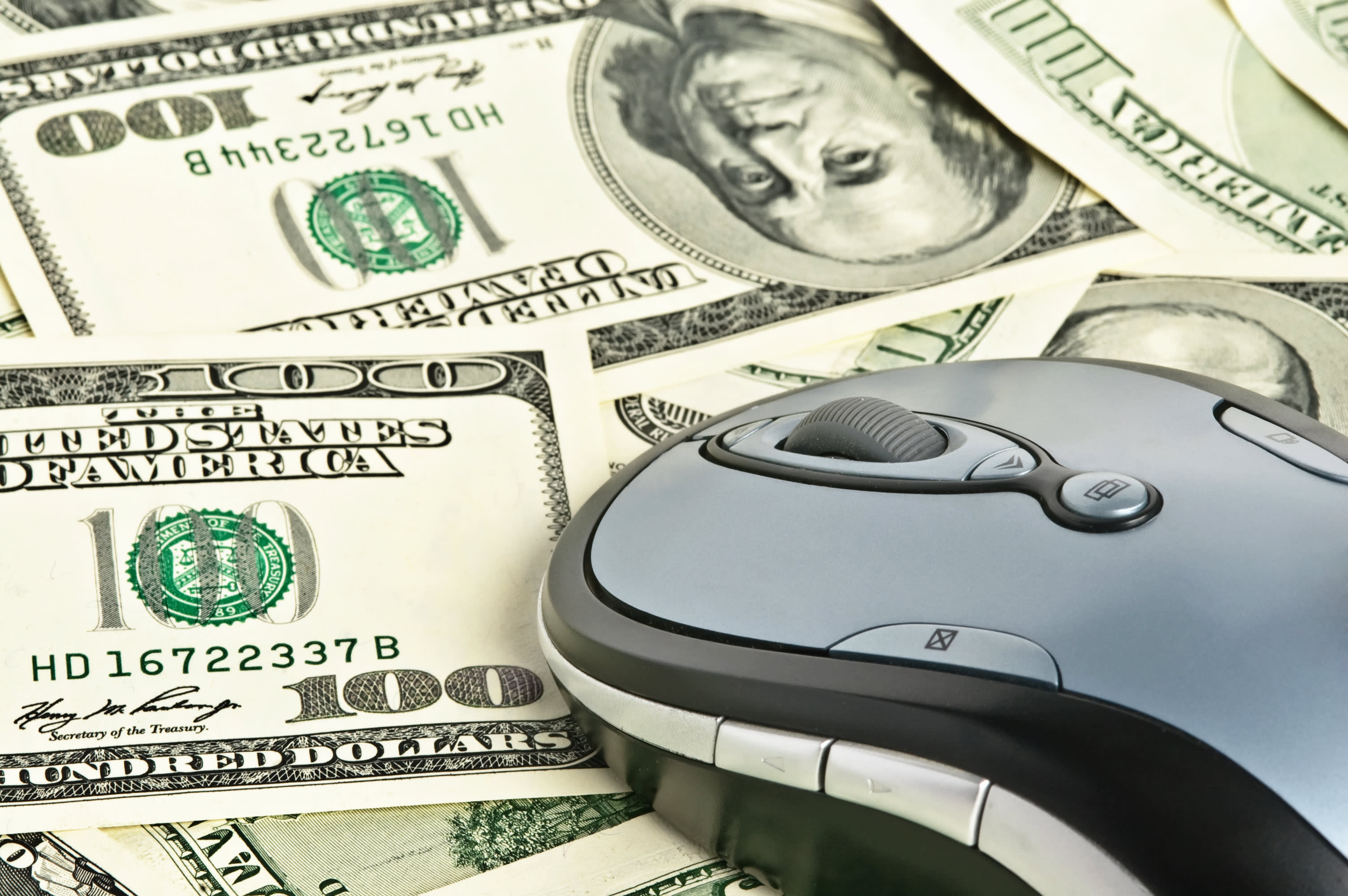 computer mouse on paper bills