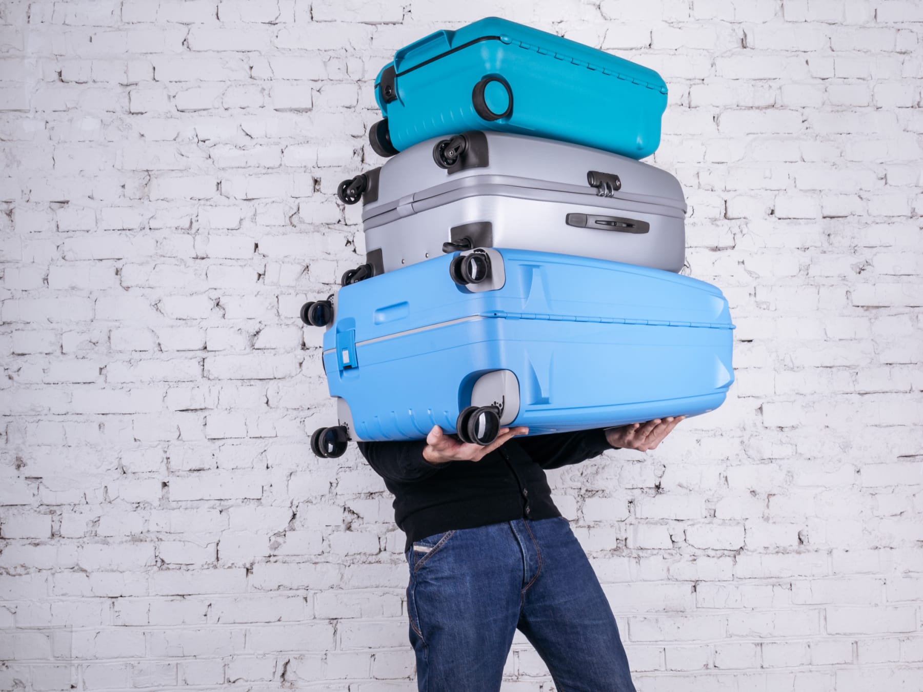 person balancing luggage