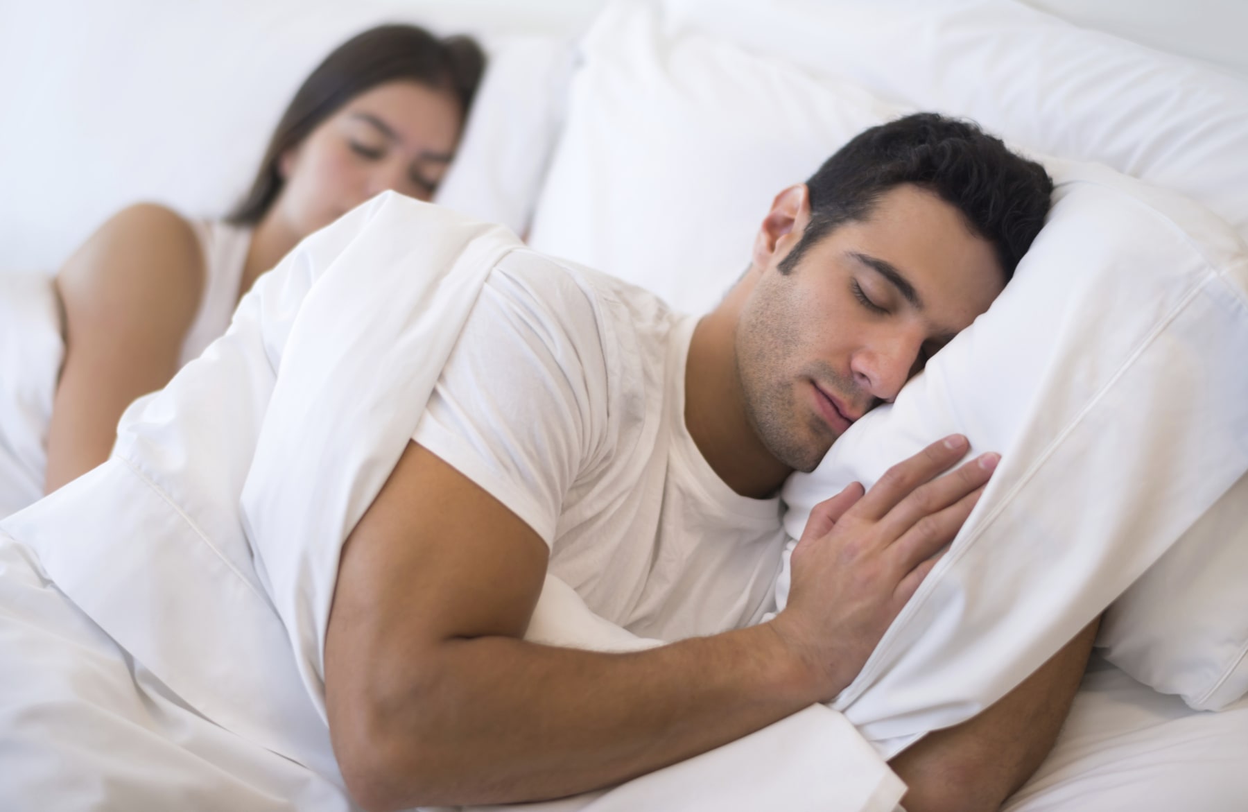 couple sleeps on bed