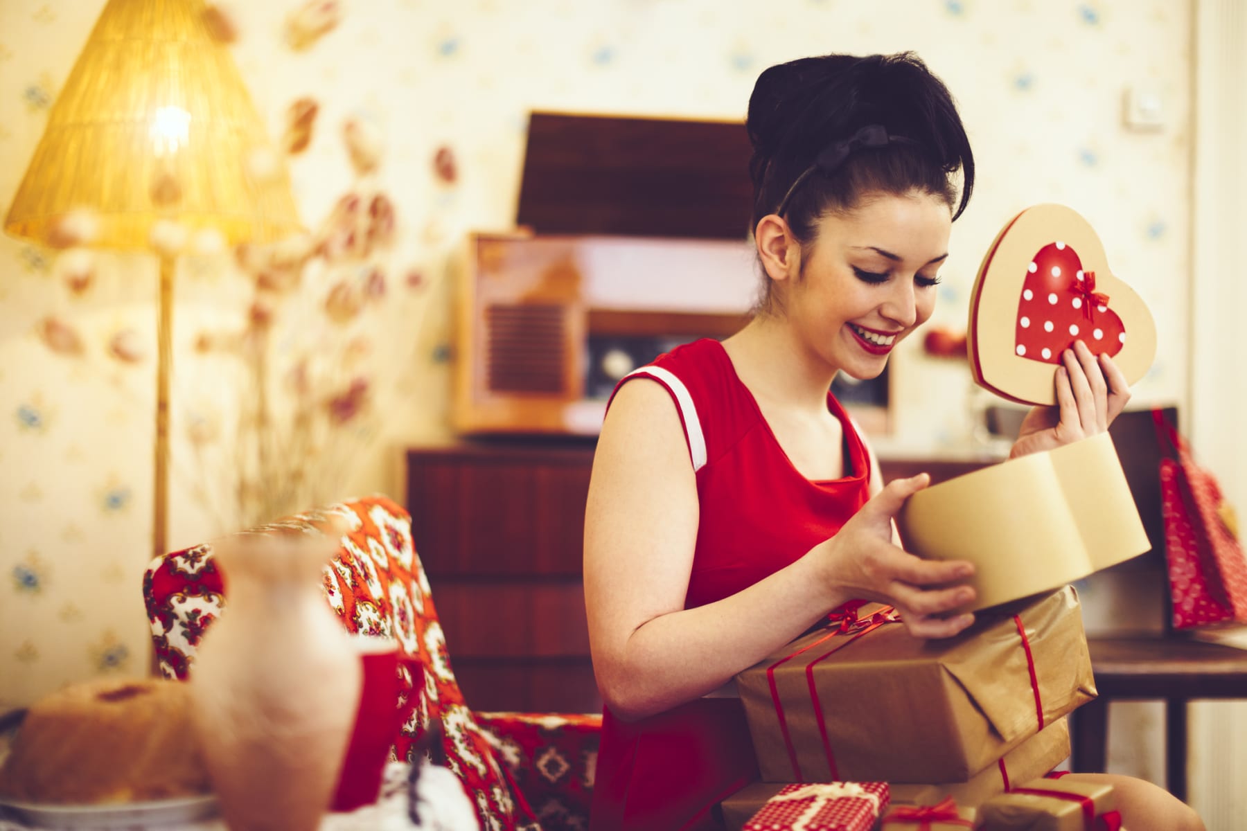 woman opening Valentine's gifts