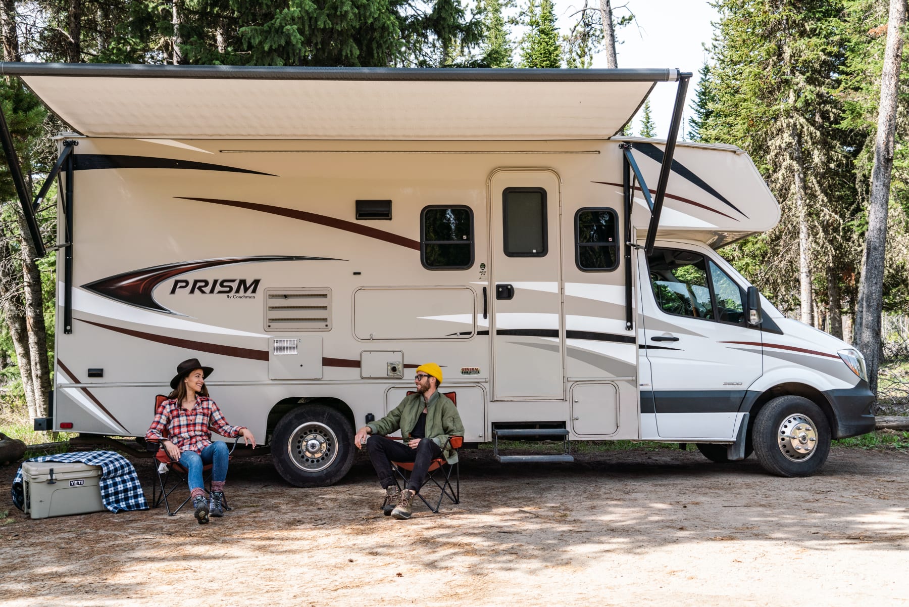 man and woman in front of RV