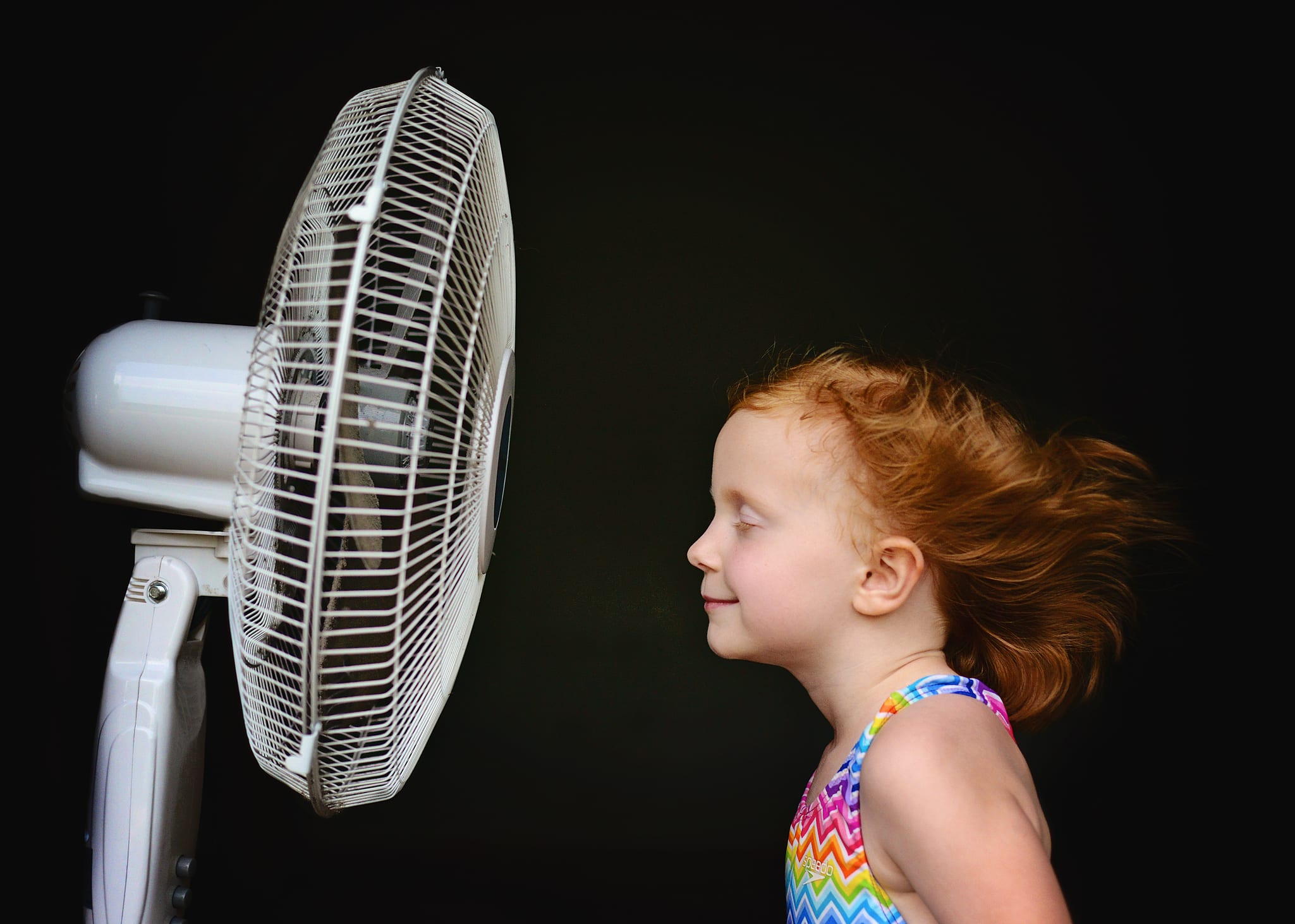 kid in front of fan
