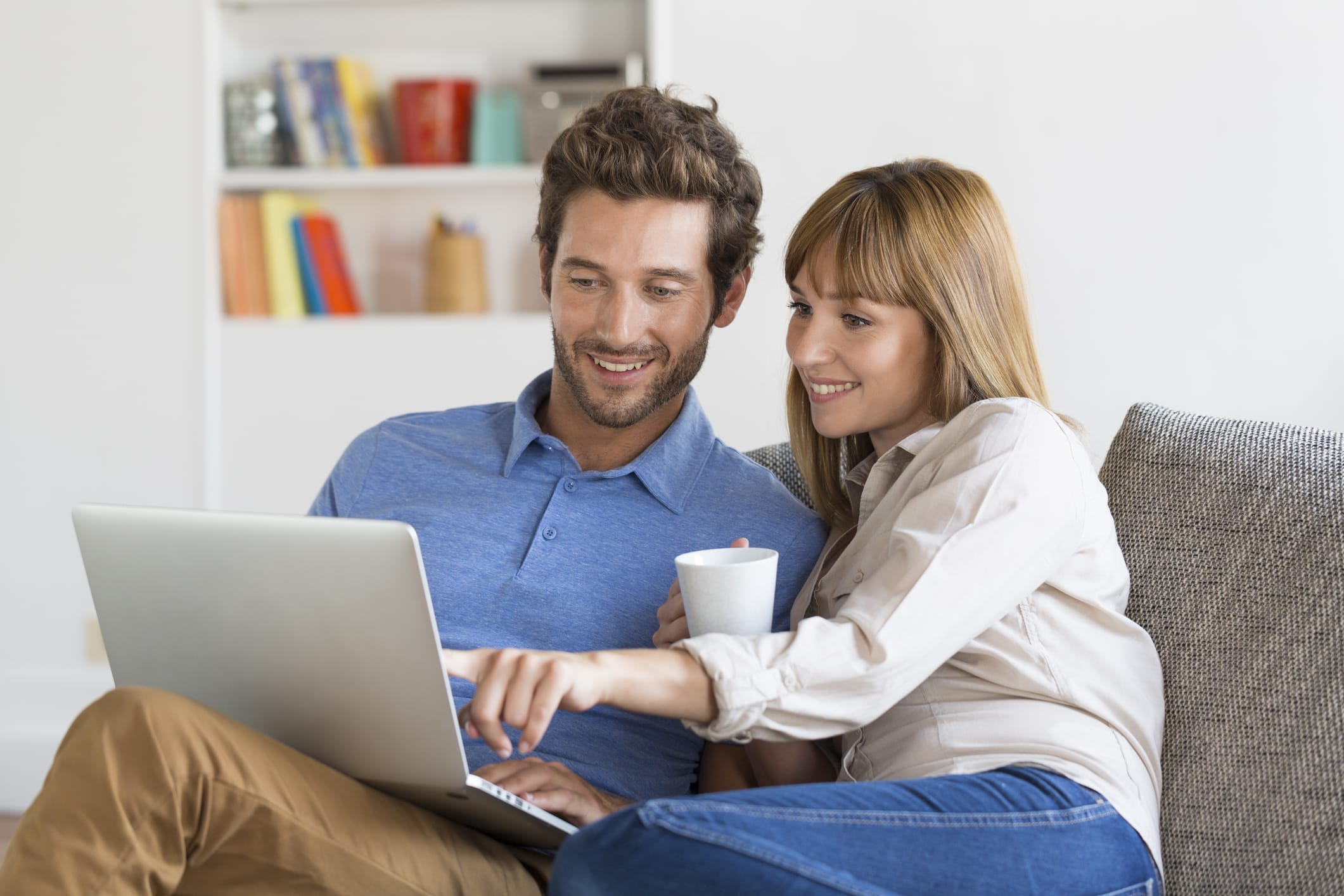 couple uses laptop