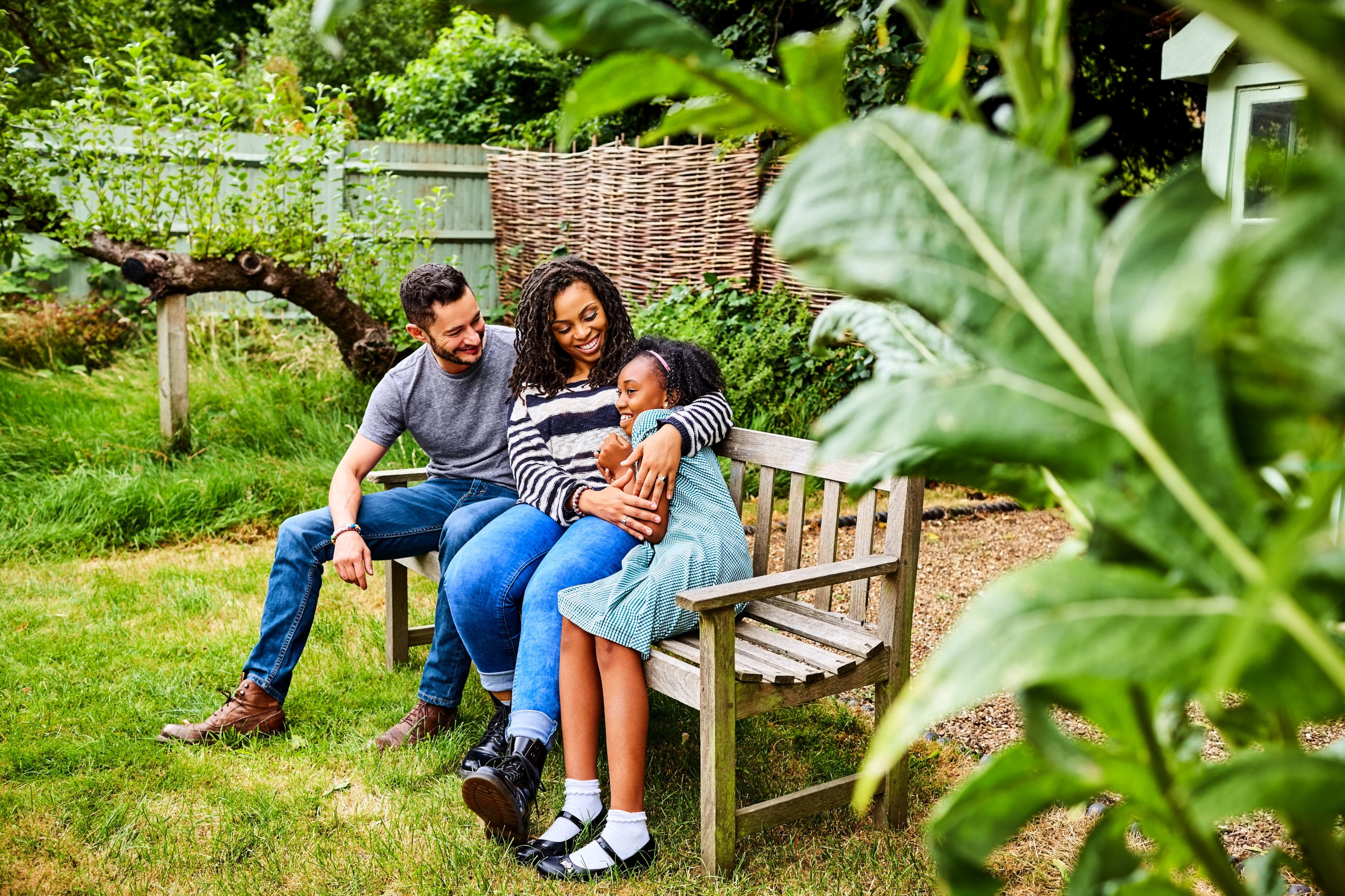 happy family sits on bench