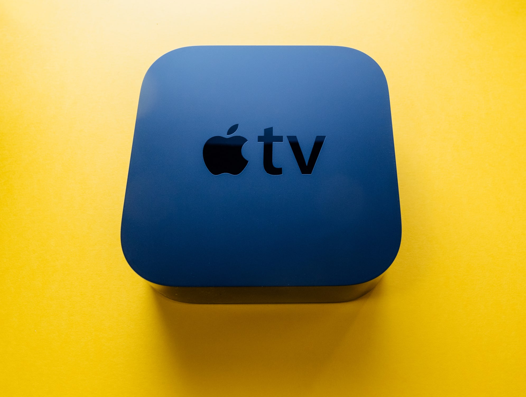 New Apple TV 4k Device Against Yellow Background