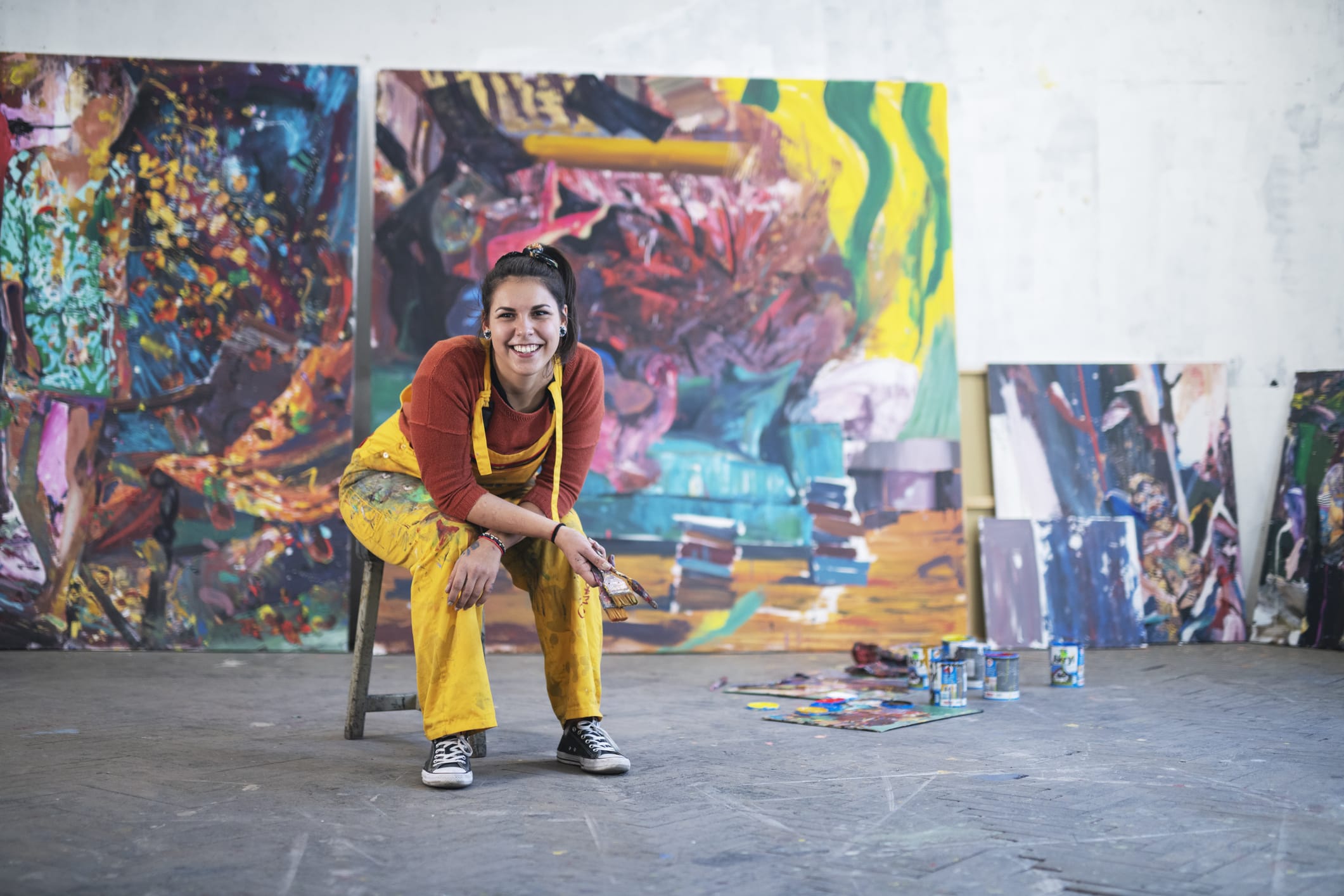 woman artist with paintings